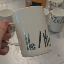 Load and play video in Gallery viewer, He / Him / His - WRAPPED UP PRONOUN MUG
